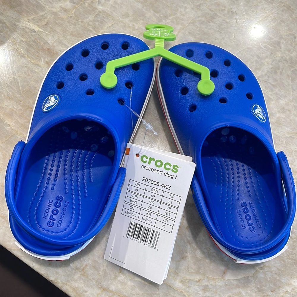Crocs blue with red stripe. Kid/ toddler size 9. Never worn. Brand new.